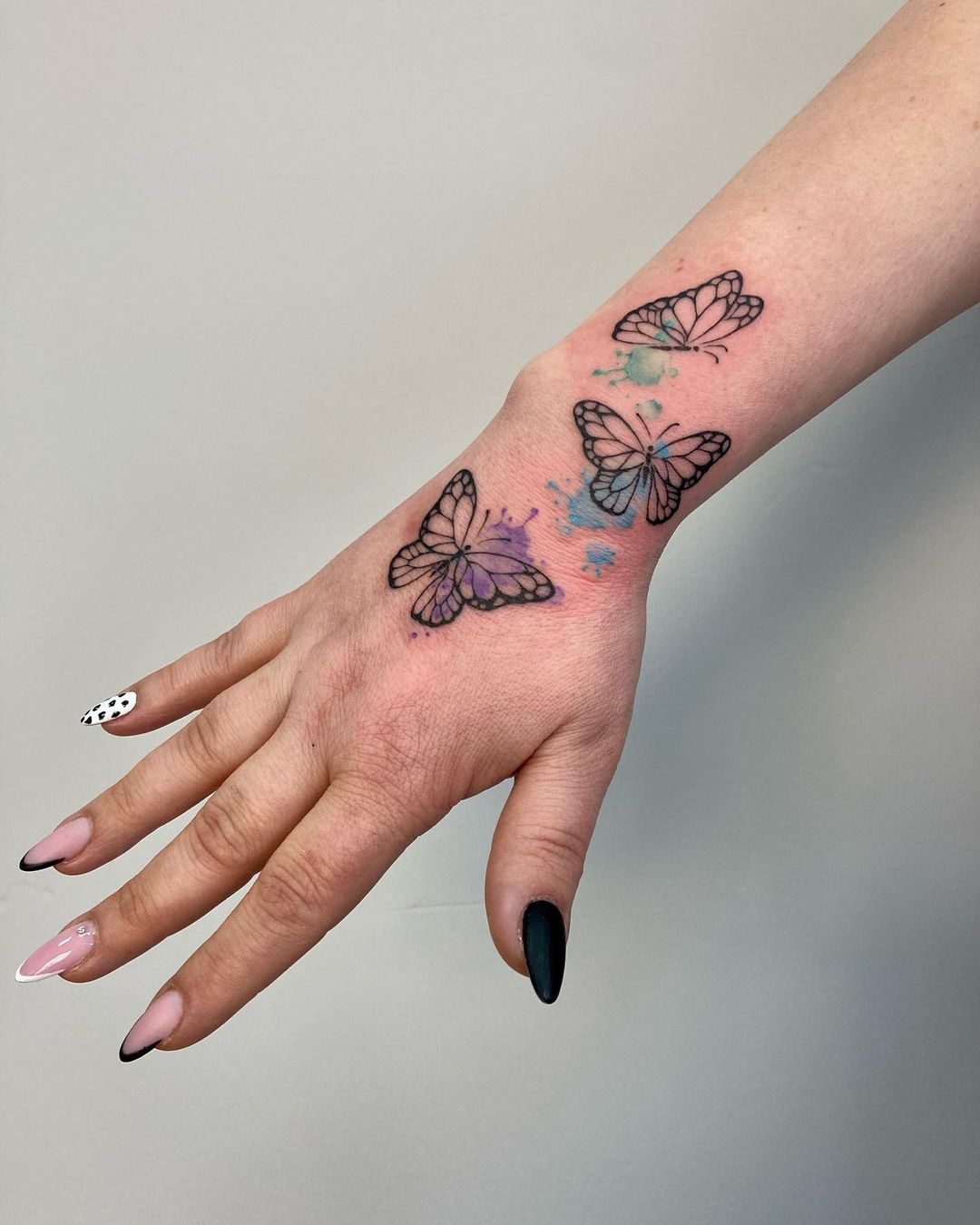 Mano donna tatuaggio di farfalle